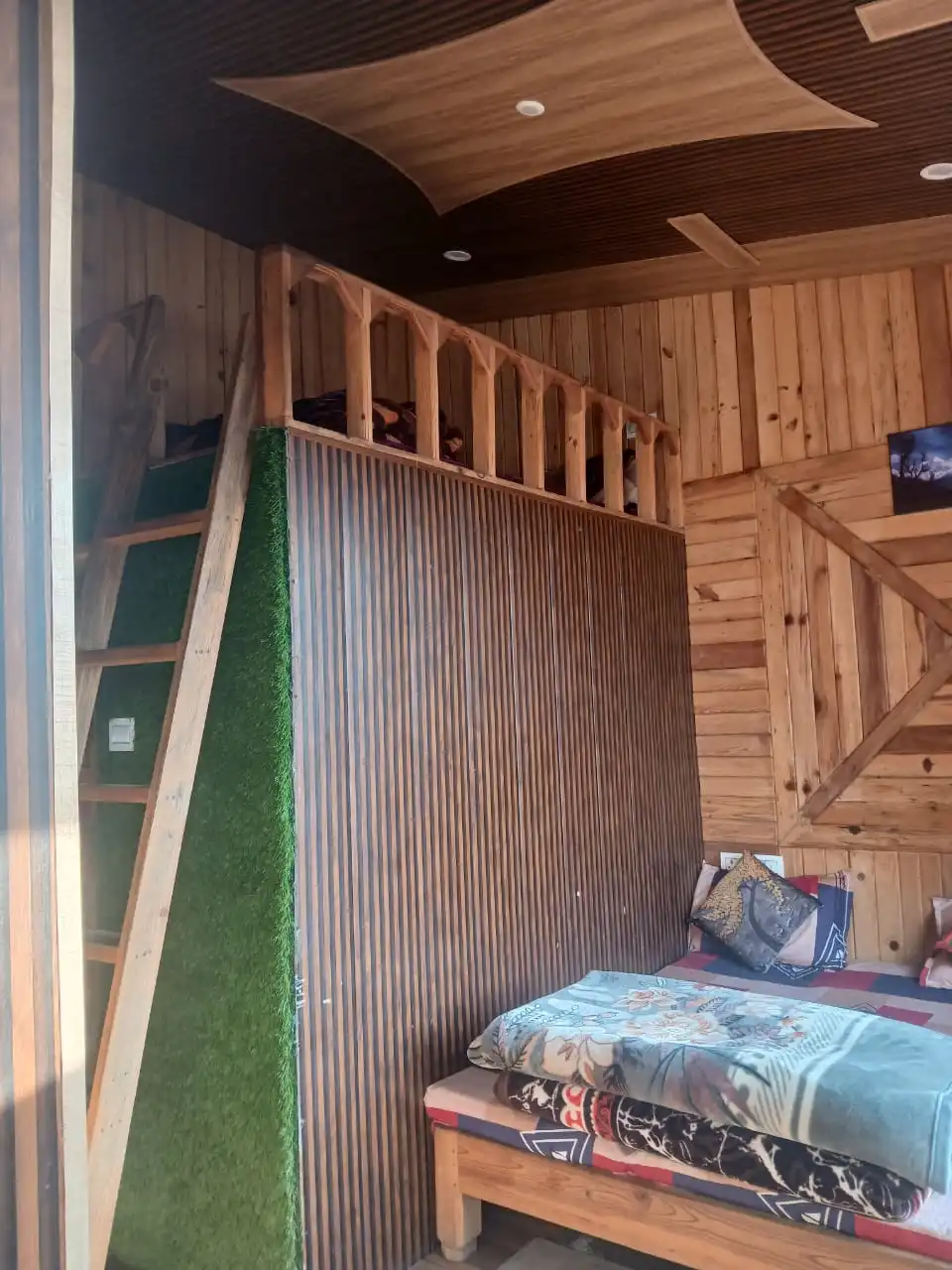 Cedar Loft bedroom with timber beams and soft natural light
